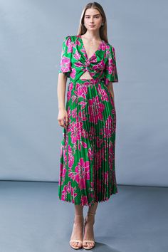 A printed woven midi dress featuring V neckline, front twist and cut out detail, short flutter sleeve, pleated skirt and elasticized back waist Look stunning in our Certified Charm Woven MIDI Dress, designed to flatter your silhouette with its structured V-neckline, intricate front twist and cut-out detail, and voluminous pleated skirt. Crafted from lightweight printed fabric, with delicate flutter sleeves and an elasticized back waist, this dress is sure to elevate your wardrobe with its sophis Vacation V-neck Pleated Midi Dress, Green V-neck Dress With Pleated Waist, Pleated V-neck Midi Dress For Vacation, V-neck Pleated Midi Dress For Vacation, Spring Dress With Twist Front And Surplice Neckline, Green Surplice Neckline Midi Dress For Brunch, Spring Midi Length Dress With Twist Front, Spring Midi Length Twist Front Dress, Spring Twist Front Midi-length Dress