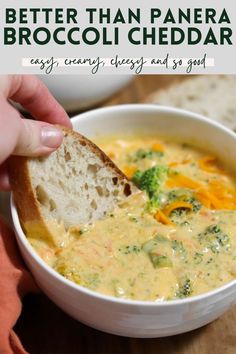 broccoli cheese soup in a white bowl with a piece of bread sticking out of it