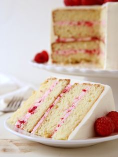 a slice of cake with raspberry filling on a plate next to the rest of the cake