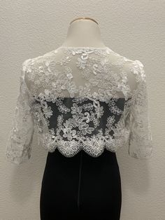 White floral lace wedding handmade bolero. Bridal and evening lace long sleeves jacket. Scalloped edgings and sleeves shrug. Corded Sequined Lace Bolero.    This elegant handmade design has a pretty scalloped lace edge all the way around and on the long-length sleeves as well. A small hook closure finishes it off at the neckline to allow movement and to show your dress or top underneath. The hand-made pearl brooch covering the hook closure gives a more luxurious and stylish look.  Sizes  S - M Lace Mother Of The Bride Dress With Long Sleeves, Long-sleeve Lace Mother Of The Bride Dress, Long-sleeved Lace Mother Of The Bride Dress, Mother Of The Bride Long Sleeve Lace Dress, Fitted Long Sleeve Lace Mother Of The Bride Dress, Fitted Lace Long Sleeve Mother Of The Bride Dress, Party Shrug With Lace Trim, Elegant Lace Patchwork For Ceremony, Elegant Lace With Patchwork For Ceremony