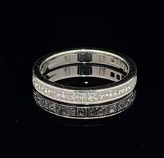 a white gold wedding band with princess cut diamonds on the inside and sides, set in 18k white gold