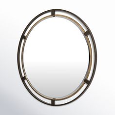 a round mirror with metal accents on it