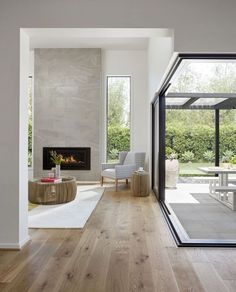 a living room filled with furniture and a fire place in the middle of a room