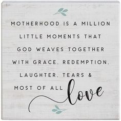 a wooden sign that says, motherhood is a million little moments that god waves together with grace redemption laughter tears & most of all