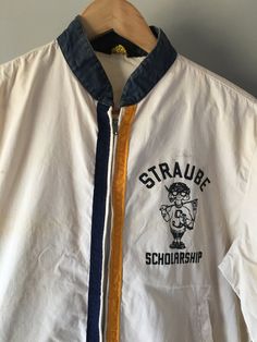 "1960s vintage Straube Scholarship windbreaker. KSU. Kansas State University. Wildcats. Americana. Collegiate jacket. College. Metal zipper. Gold & navy strips of trim line the edges of the zipper. Men's size M. Label reads - \"Nortex Advertised in Life\" Fantastic patina with age. Perfectly stained and torn - please review photos before ordering. Zipper is in working order. There are pockets, but one has a large hole in the bottom. And the elastic at the back waist has lost it's stretch. Fr Vintage White Outerwear With Graphic Print, Vintage White College Outerwear, Vintage White Outerwear For College, Retro Cotton Outerwear For School, Vintage White Crew Neck Outerwear, White Vintage Crew Neck Outerwear, Kansas State University, Kansas State, Metal Zipper