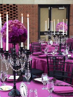 the tables are set with purple linens and centerpieces