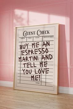 a sign that says guest check in front of a pink wall