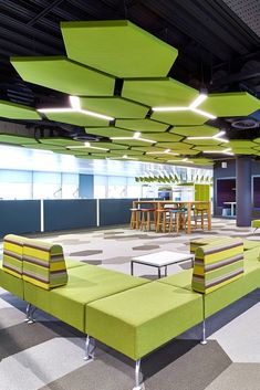 an office lobby with green and yellow furniture