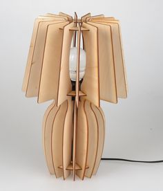 a lamp made out of wood with a light bulb in the middle