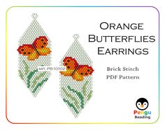 an orange butterfly earrings with green leaves in the middle and yellow butterflies on it's back