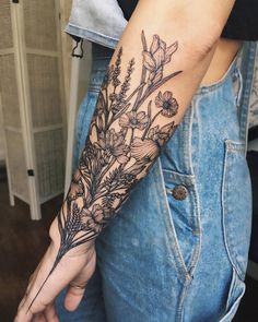 a woman's arm with flowers on it