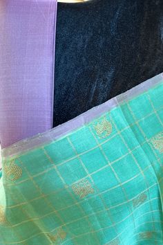 This stunning borderless kanjivaram silk saree in pastel green shot with rama blue is handwoven. The selvedge and the grand pallu is in mauve shot with lavender color. The body is adorned with horse and yazhi motifs enclosed in checks in gold zari. The blouse piece is cut. and in the same color as the pallu. Approximate Length 6.5 mtrs (inclusive of blouse length) Approximate height - 44 - 50” Approximate weight - 1.6 lbs Saree comes with fall, picot and tassels done. Blouse piece is cut. Kindly Note : The colors you see on your device may vary due to the color reproduction, brightness and resolution of individual devices. If you'd like more clarity before your purchase, please contact our support team. Green Shot, Kanjivaram Silk Saree, Silk Cotton Sarees, Cotton Sarees, Lavender Color, Pastel Green, Blouse Length, Support Team, Handloom Saree