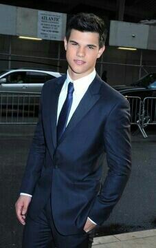 a young man wearing a suit and tie