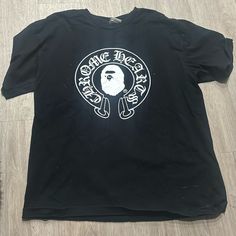 a black t - shirt with a white logo on the front that says gang boss