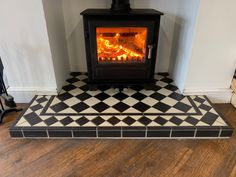 a black and white checkered floor with a wood burning stove