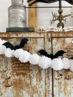 some white and black decorations on an old cabinet