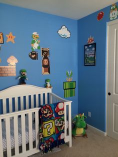 a baby's room decorated in blue and green with super mario decorations on the wall