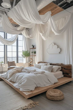 a large bed sitting in the middle of a room with lots of white drapes