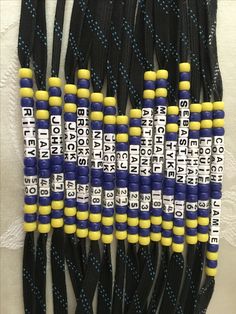 several black and yellow cords with white letters on them are lined up in the same pattern