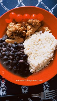 an orange plate topped with rice and beans