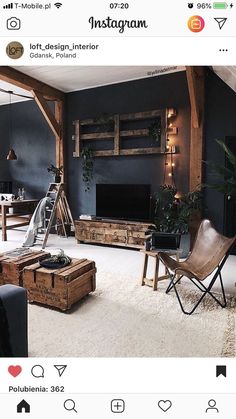 an instagram photo of a living room with dark blue walls and white carpeting