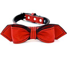 a red bow tie on a black leather collar