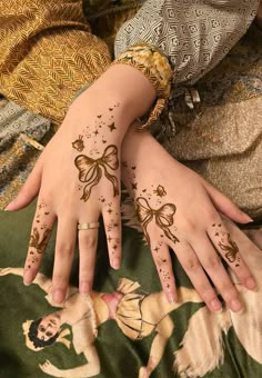 two hands with henna tattoos on them