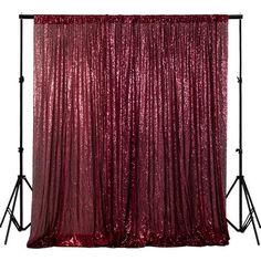 red sequinized backdrop with black metal tripod stands and white backdrop behind it