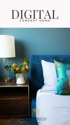 a blue bed with pillows and a lamp next to it on top of a night stand