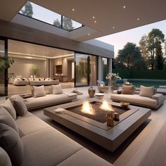 a large living room with couches and a fire pit in the middle of it