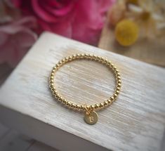 "THIS ITEM SHIPS FOR FREE! Introducing the Petite Initial Charm Bracelet. This listing is for one gold-filled bracelet made with 4mm beads with a hand-stamped initial charm. The charm is petite and measures 3/8\". Please review all of the photographs to see how the charm compares in size to a dime. This is the perfect way to add a little something to your gold-filled bead bracelet. I especially like this tiny charm for tweens/teens or when you want to add multiple charms to your bracelet. Please Gold Bead Bracelet, Charm Bracelet Gold, Initial Charm Bracelet, Bracelet Stacking, Tiny Charm, Gold Bead Bracelets, Gold Charm Bracelet, Birthstone Charms, Initial Charm