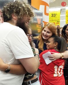 a group of people hugging each other in a store