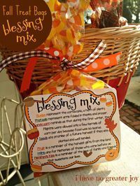 a basket filled with lots of candy sitting on top of a wooden table next to a sign