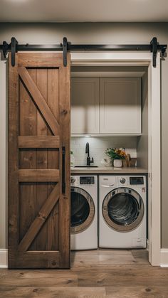 a washer and dryer in a small room with an open door to the kitchen