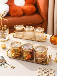 the table is decorated with gold and glass containers