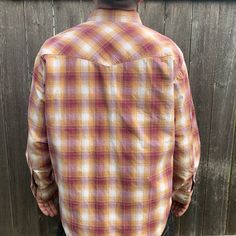 This well made Wrangler is a lovely color and has beautiful pearl snap buttons to complement the cowboy cut. Made in the USA, 100% cotton. Good condition with very little wear, just one tiny mark on sleeve.-Model size men’s Large-Approximate measurement when laid flat:24" armpit to armpit 20" shoulder to shoulder23" shoulder to cuff31" back of collar to hem Casual Shirt With Button Closure For Western-themed Events, Western Style Snap Button-up Shirt, Western Snap Button-up Shirt, Western Style Snap Button Shirt, Western Shirt With Buttons For Ranch, Western Style Shirt With Buttons For Ranch, Western Style Shirt With Buttons For Rodeo, Western Style Shirt For Rodeo, Western Shirt For Rodeo