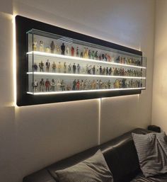 a wall mounted display case filled with star wars figurines in a living room