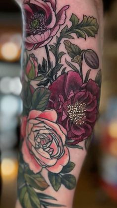 a close up of a person's leg with flowers on it