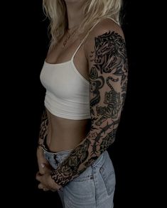 a woman with tattoos on her arm and chest