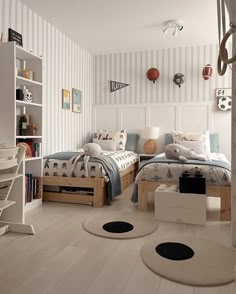 a bedroom with two twin beds and a desk in front of the bed is white, striped wallpaper