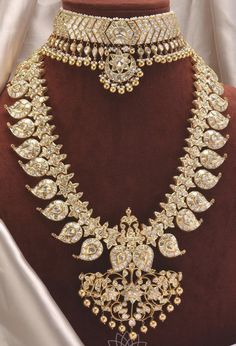 an elaborate necklace and earring set on display