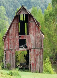 an old red barn in the country side