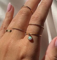 "A striking yet simple simulated opal charm ring that will elevate any look! Style this beautiful gem with our other stack rings.   *Model may be shown with this item layered with other rings not included in this listing. These items are available and sold separately in our Shop. Links Below. . . . . . . . . . . . . . . . . . . . . . . . . . . . . . . . . . . . . . . . . . . { D E T A I L S } * Made entirely of 14k Gold Filled * 4mm Simulated Opal  * Highly polished * each sold separately . . . . . . . . . . . . . . . . . . . . . . .  { M A T E R I A L S } 14k GOLD FILLED + 14k ROSE GOLD FILL Gold filled is a thick layer of 14k gold pressure bonded over a base metal. It contains 100 times more gold than gold-plated jewelry, is tarnish-resistant, beautiful, and wears like solid gold. It is Dangle Ring, Opal Stacking Ring, Stack Rings, Charm Ring, Ring Opal, Ring Bezel, Gold Ring Stack, Charm Rings, Stacking Ring