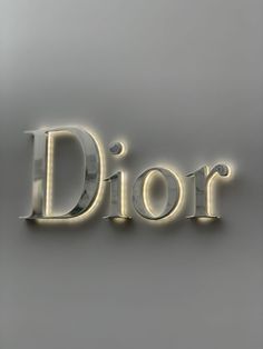 the word dior is illuminated in gold and silver