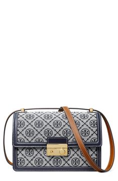 Monogram logo jacquard makes a signature statement on a structured bag furnished with a divided interior and convertible shoulder strap. Front flap closure Pull-through shoulder strap Slip pocket beneath exterior flap Dual interior compartments with center zip-pocket divider Structured silhouette with flat base for stability Lined Cotton/textile with leather trim Imported Tory Burch Shoulder Bag, T Monogram, Structured Bag, Womens Designer Handbags, Monogram Pattern, Monogram Bag, Monogrammed Leather, Designer Shoulder Bags, Monogram Logo