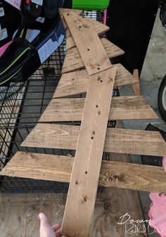 a wooden christmas tree sitting on top of a table