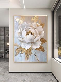 a large white flower on a blue and gold background in a living room with grey walls