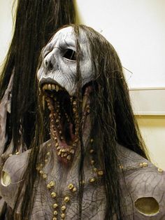 a creepy mask with long hair and teeth