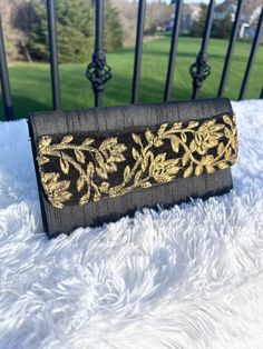 This is our gorgeous clutch that comes in a black color with a yellow and red design in the front. The clutch closes with a magnetic button and there is also a zipper in the inside for your more valuable items. It's the perfect size and will elevate any outfit! DIMENSIONS:  10 inches x 6 inches Black Pouch Wallet For Evening, Black Pouch Clutch For Wedding, Elegant Black Pouch Wallet, Black Pouch Evening Bag For Wedding, Chic Black Envelope Wallet, Black Envelope Wallet As A Gift, Traditional Black Evening Bag, Traditional Black Formal Bag, Black Clutch Wallet For Evening