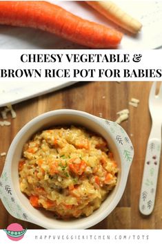 a bowl filled with rice and carrots next to two forks